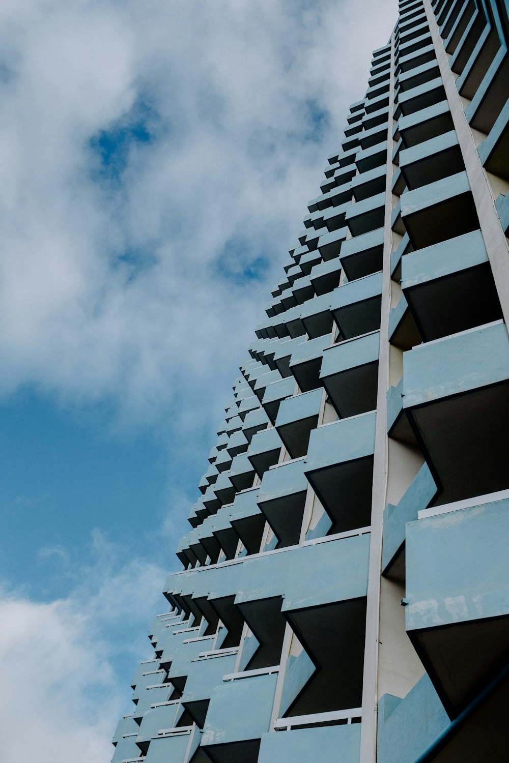 a very tall building with many balconies on it