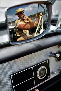 a man driving a car while talking on a cell phone