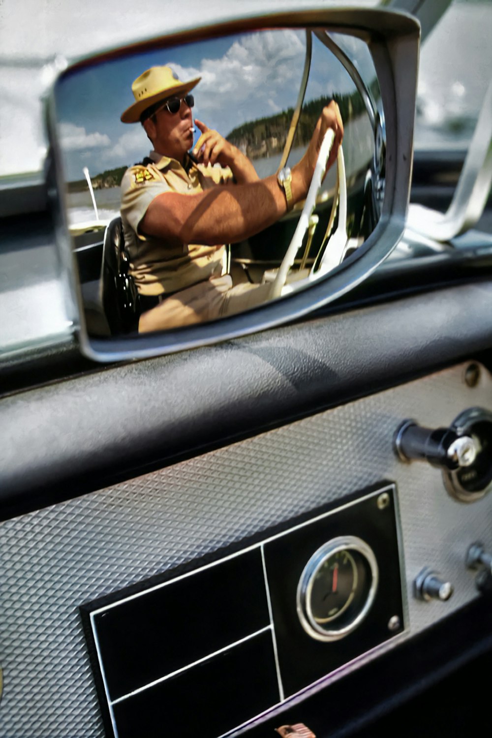 a man driving a car while talking on a cell phone