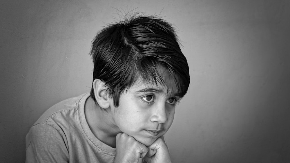 a black and white photo of a young boy