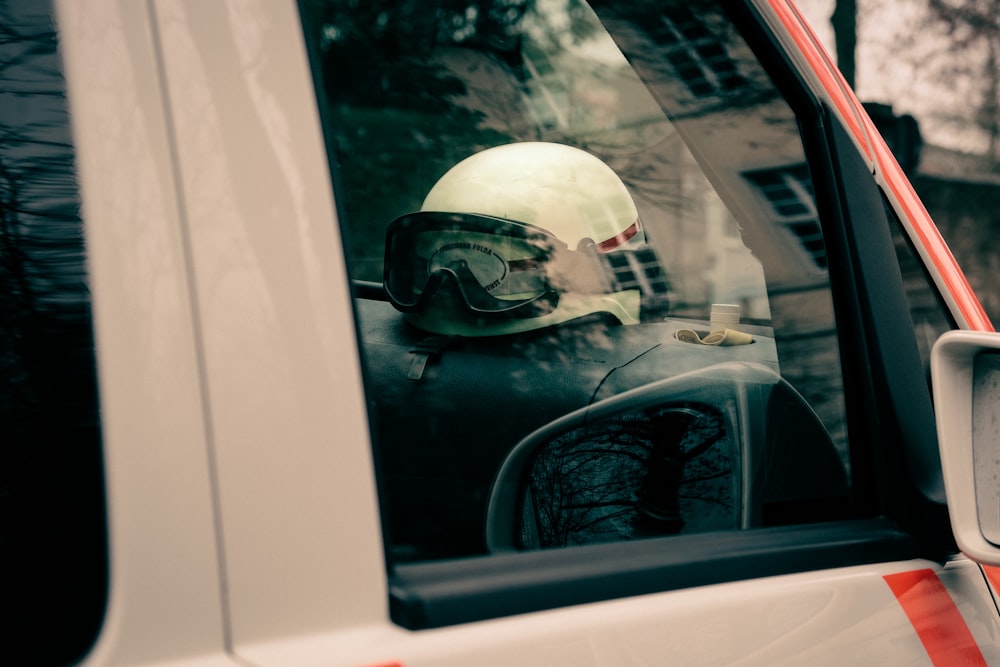 a white truck with a helmet and goggles on