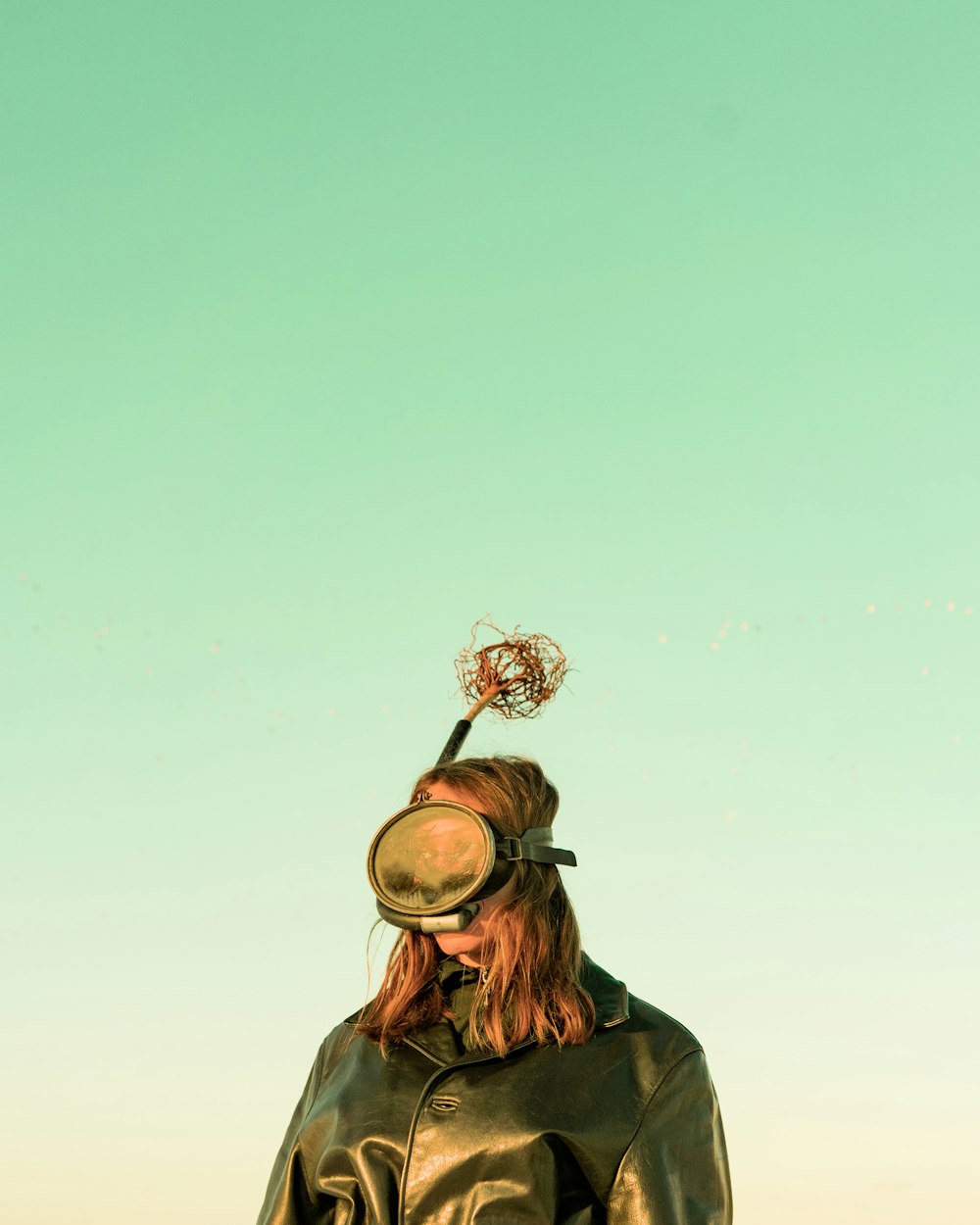 a woman in a leather jacket with a basketball hoop on her head