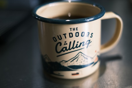 a cup of coffee sitting on top of a table