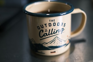 a cup of coffee sitting on top of a table