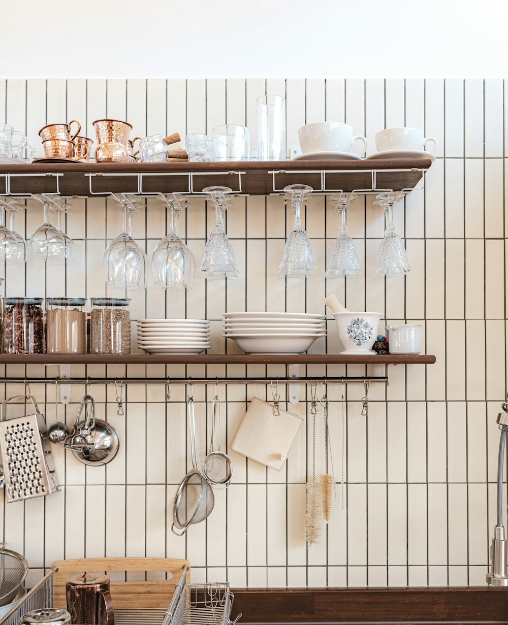 a kitchen with a shelf filled with dishes and glasses