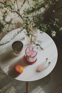 a table with a vase of flowers and a candle on it