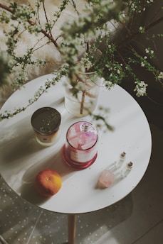 a table with a vase of flowers and a candle on it