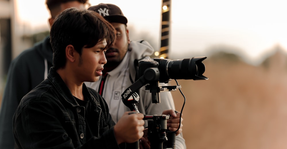 a man holding a camera and recording a video