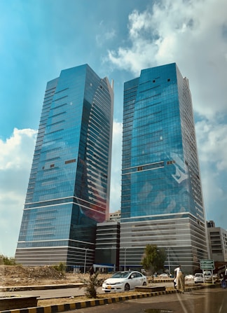 a couple of tall buildings sitting next to each other