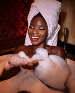 A peaceful woman wrapped in a soft towel, smiling after a rejuvenating massage.