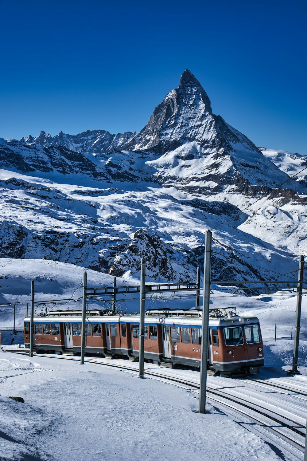 a train traveling through a snow covered mountain