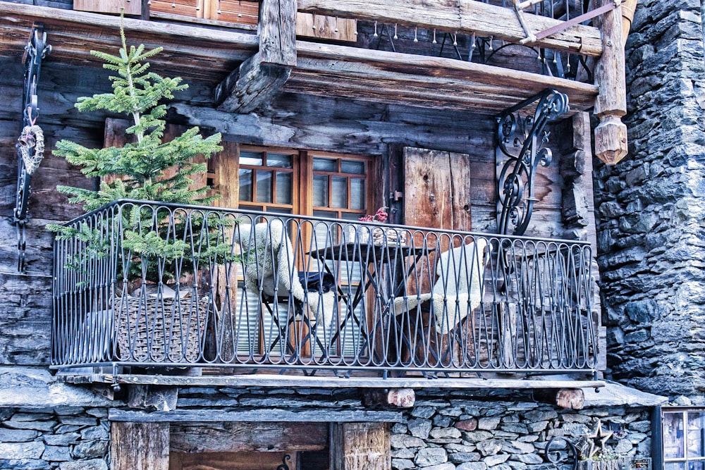 a wooden building with a balcony and iron railing