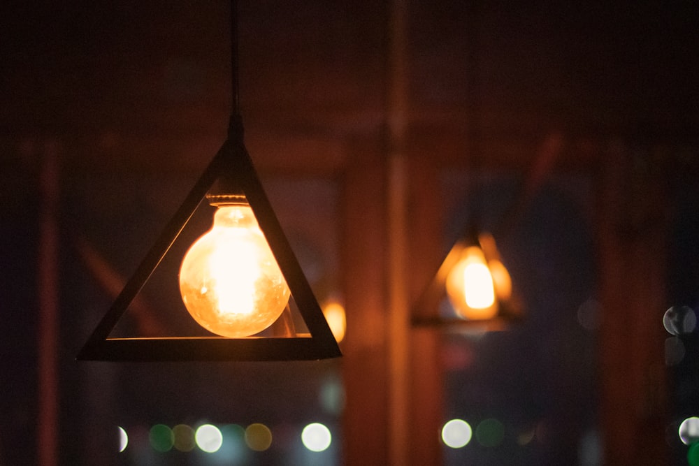 a light bulb hanging from a ceiling in a dark room