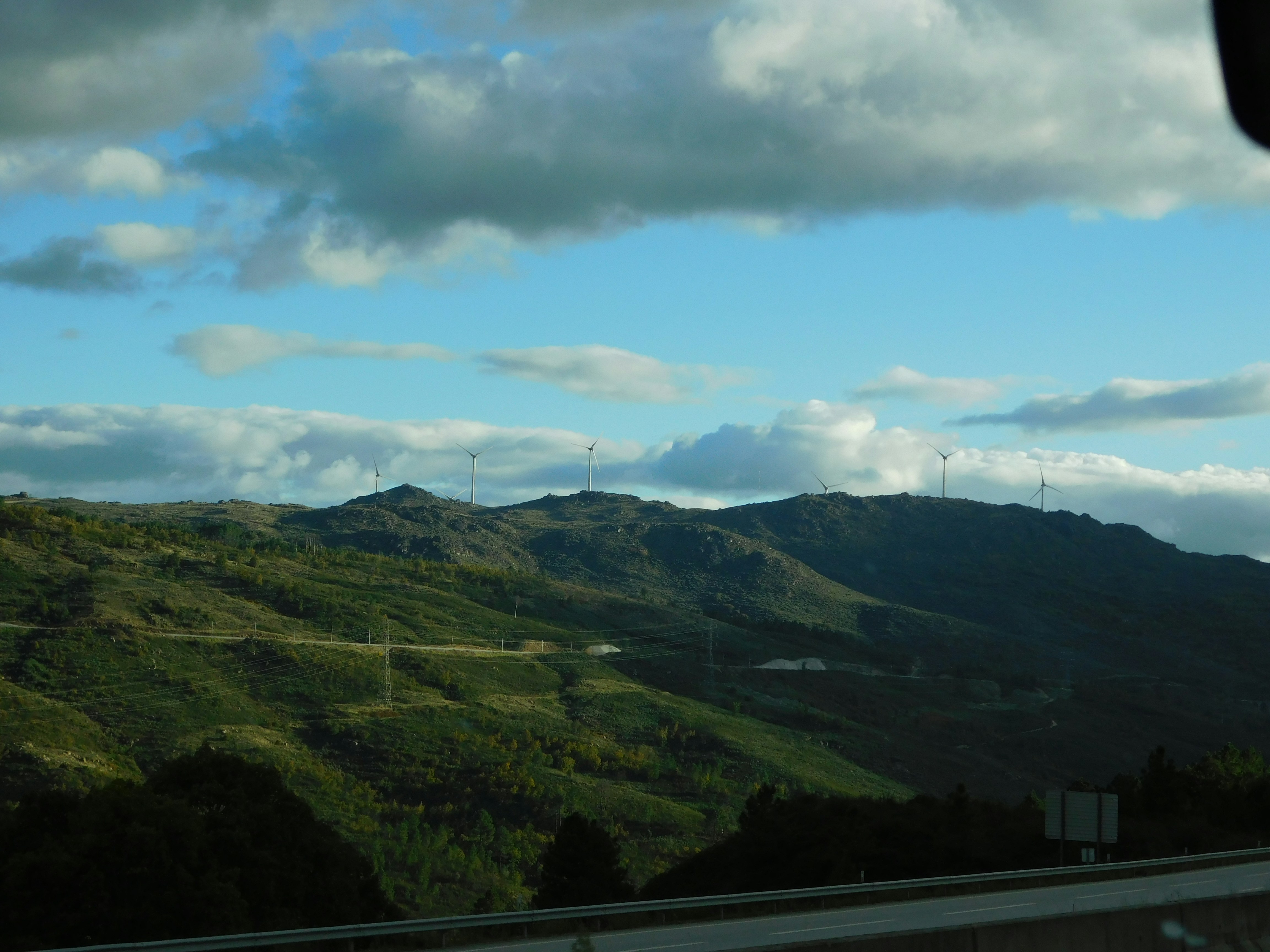 a scenic view of a mountain range with wind mills in the distance, Landscape in Portugal from the car