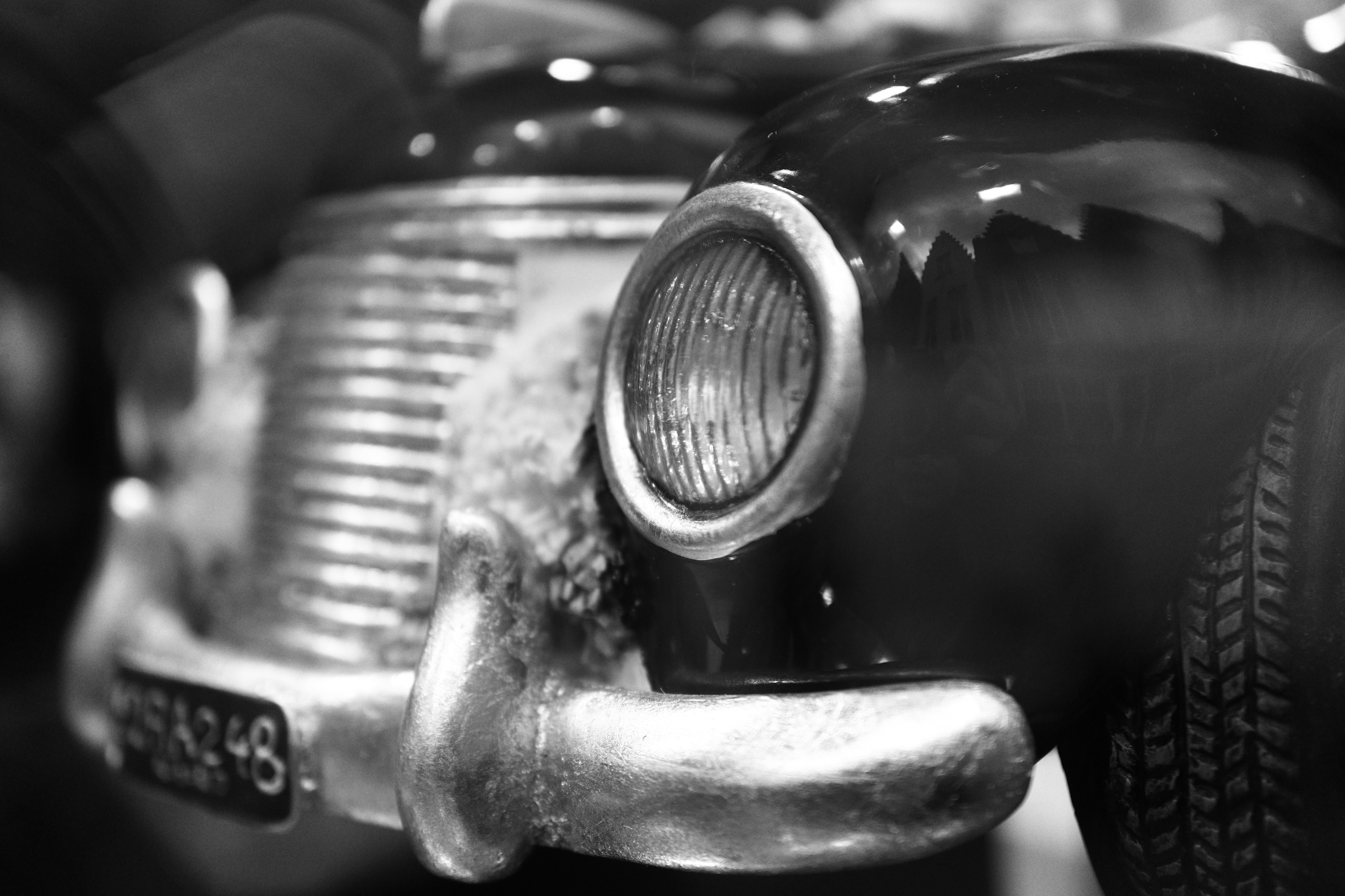a black and white photo of an old car