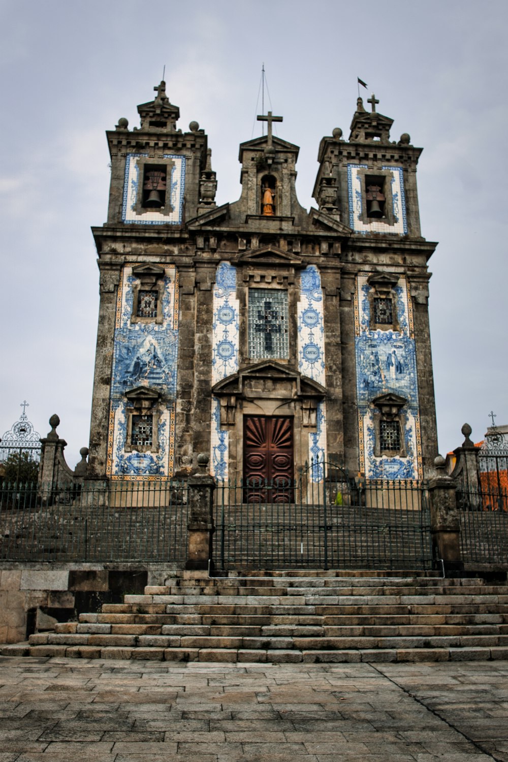 an old church with blue and white tiles on it