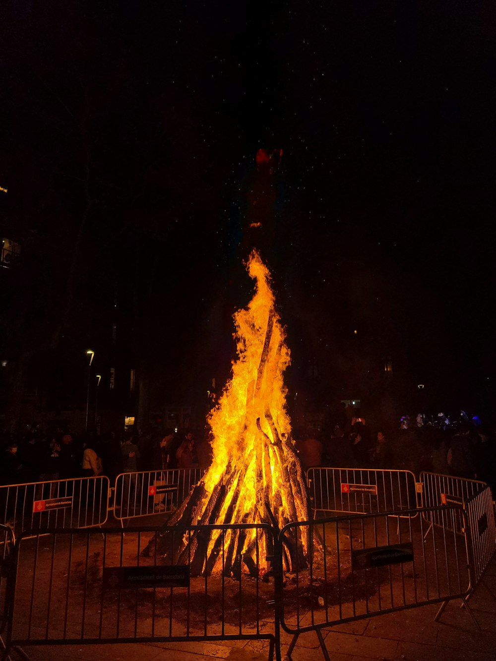 a large bonfire is lit up in the dark