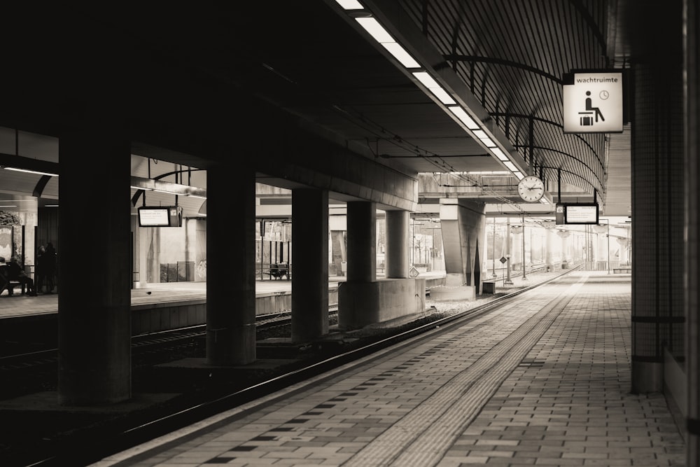 a black and white photo of a train station