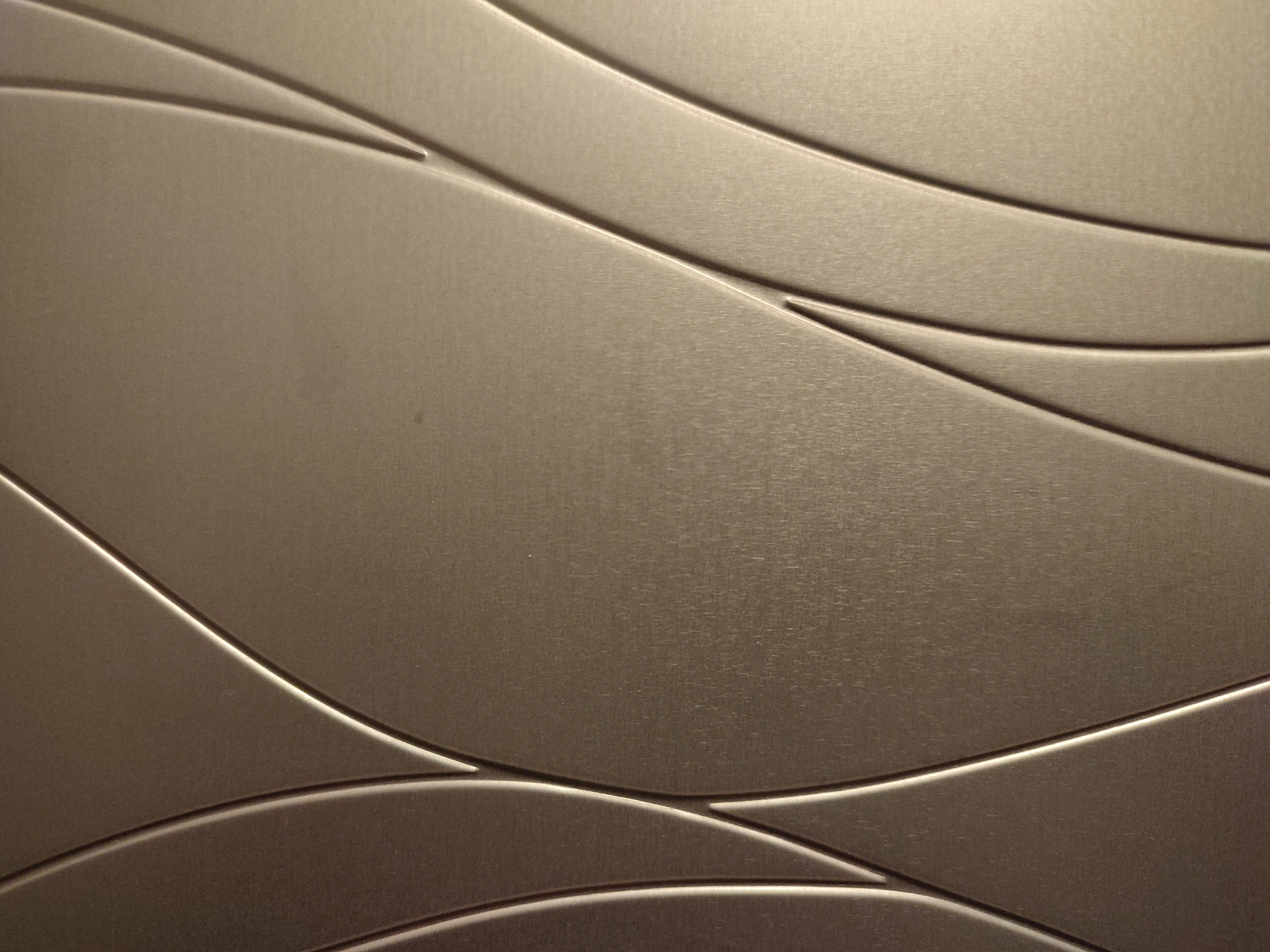 a close up of a metal surface with wavy lines