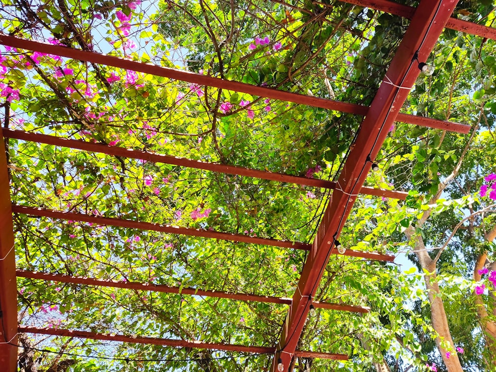 a red metal structure with pink flowers on it