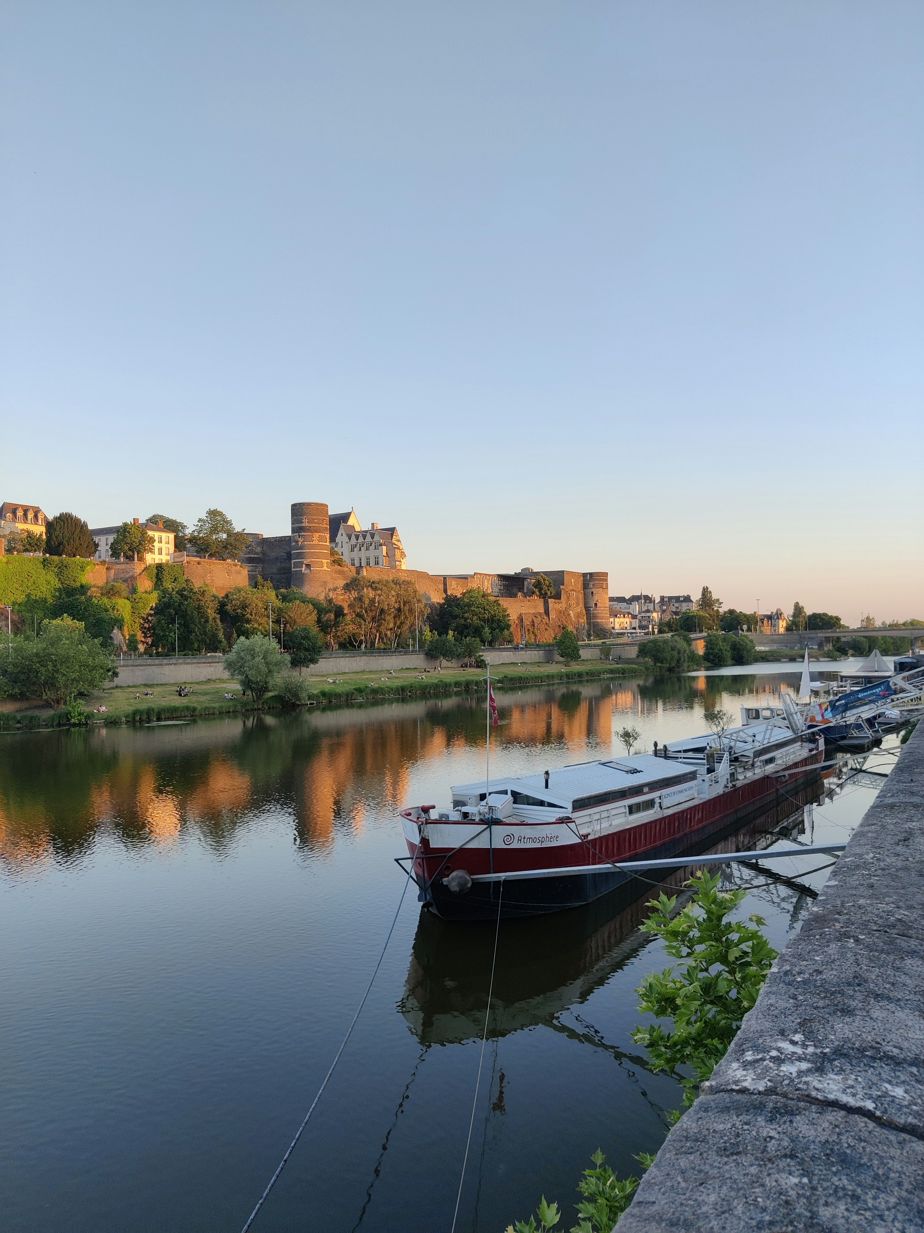 a row of boats sitting on top of a river