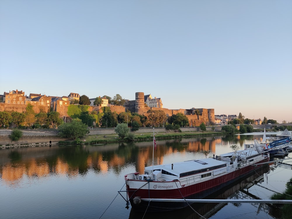 a boat is docked in the water next to a city