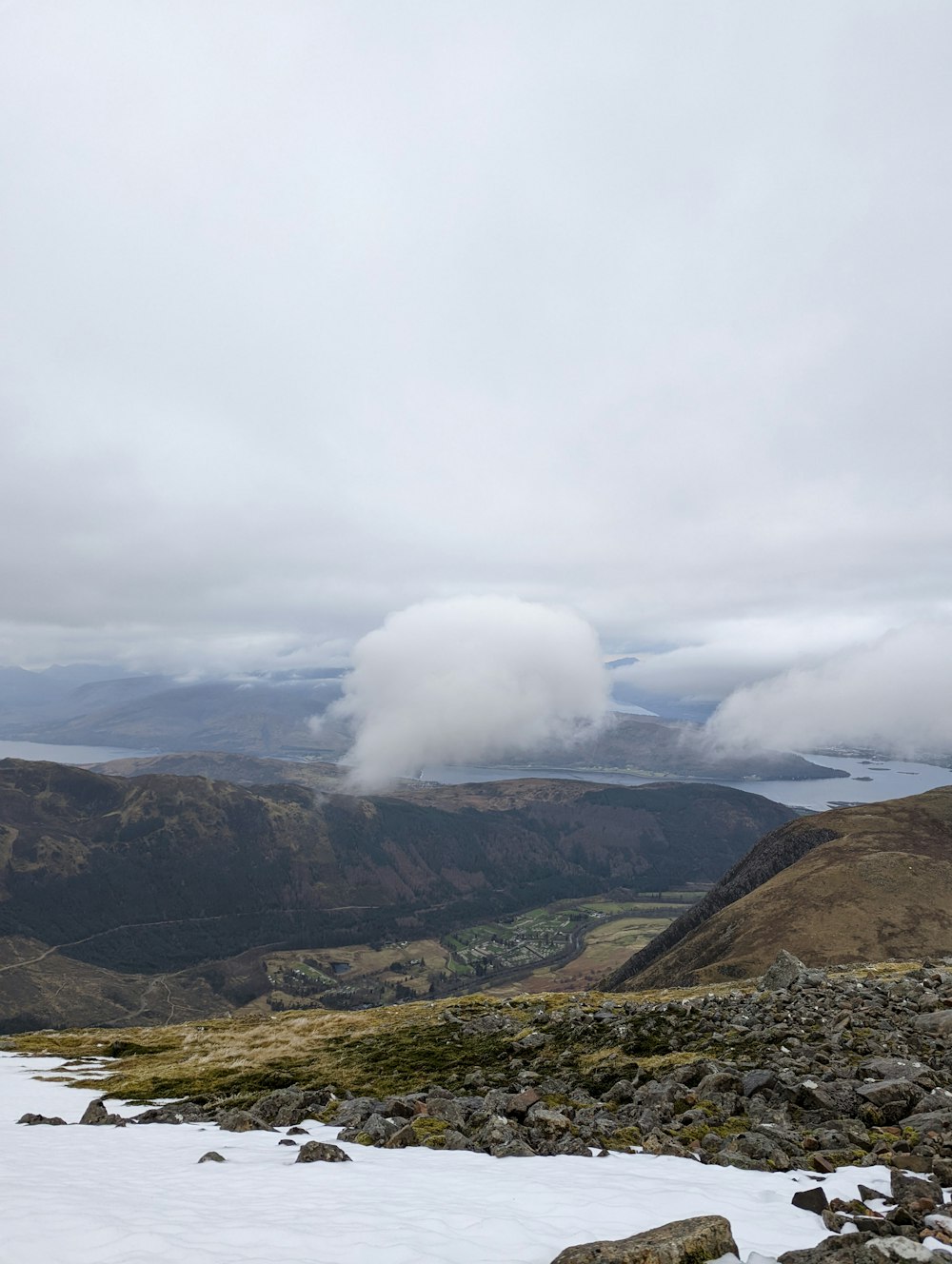 a view of a mountain range with snow on the ground