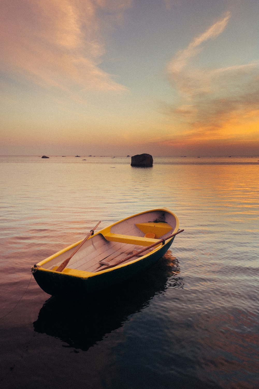 a small boat floating on top of a body of water