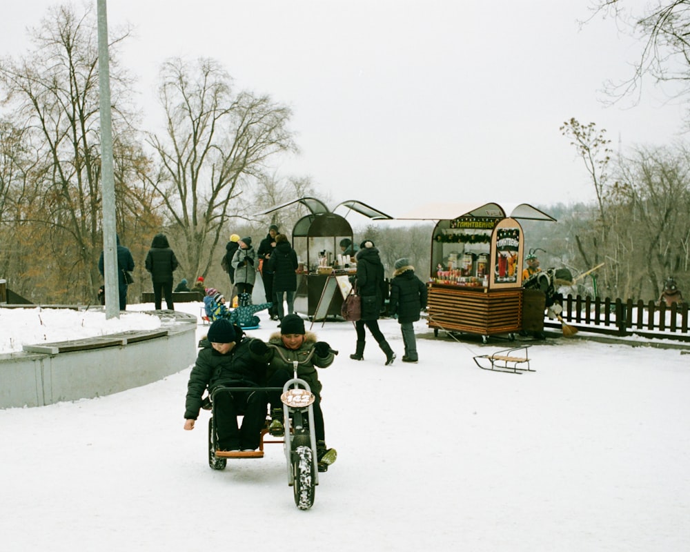 a man sitting in a wheel chair in the snow