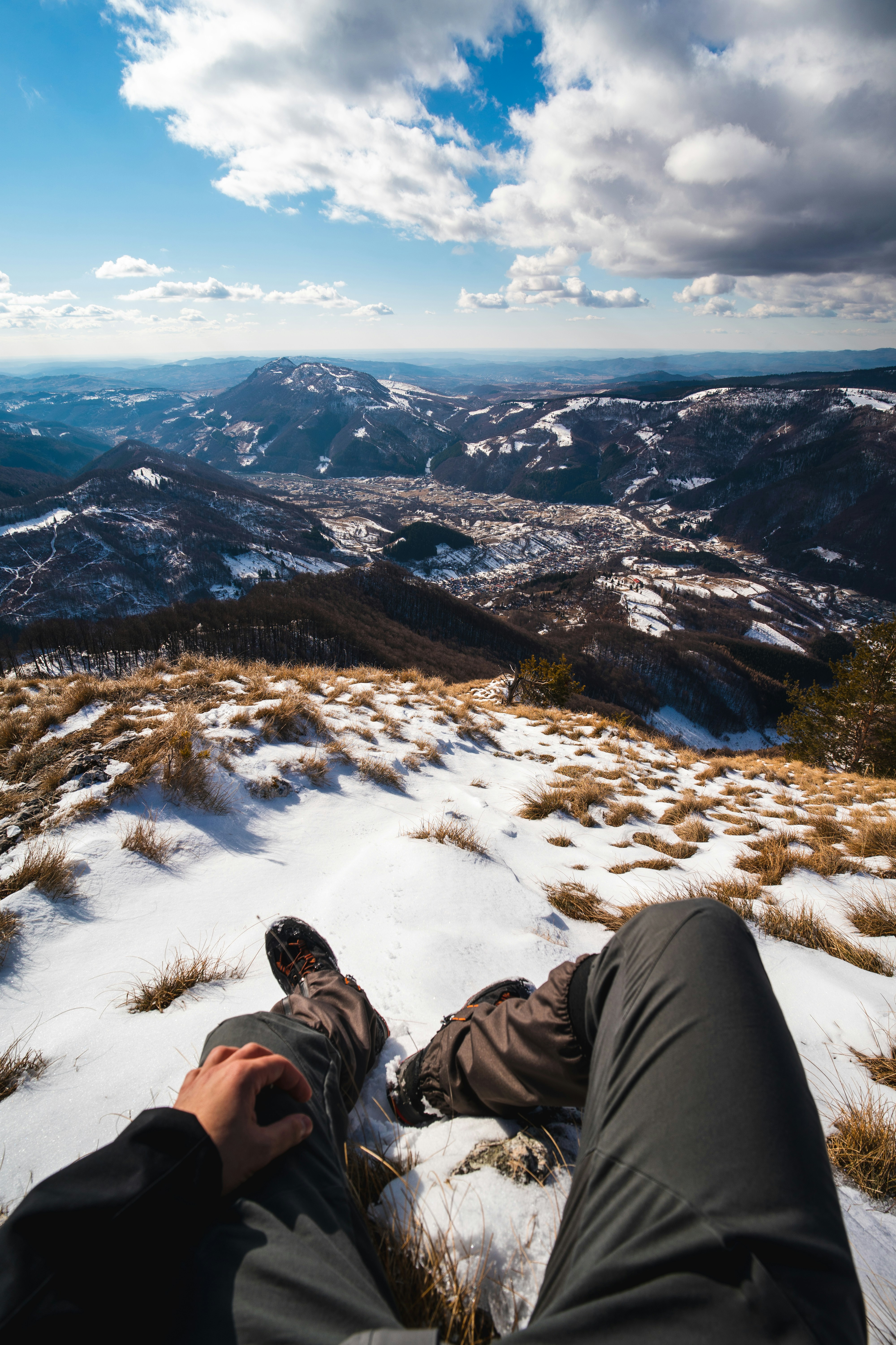 A person laying in the snow on top of a mountain photo – Free ...