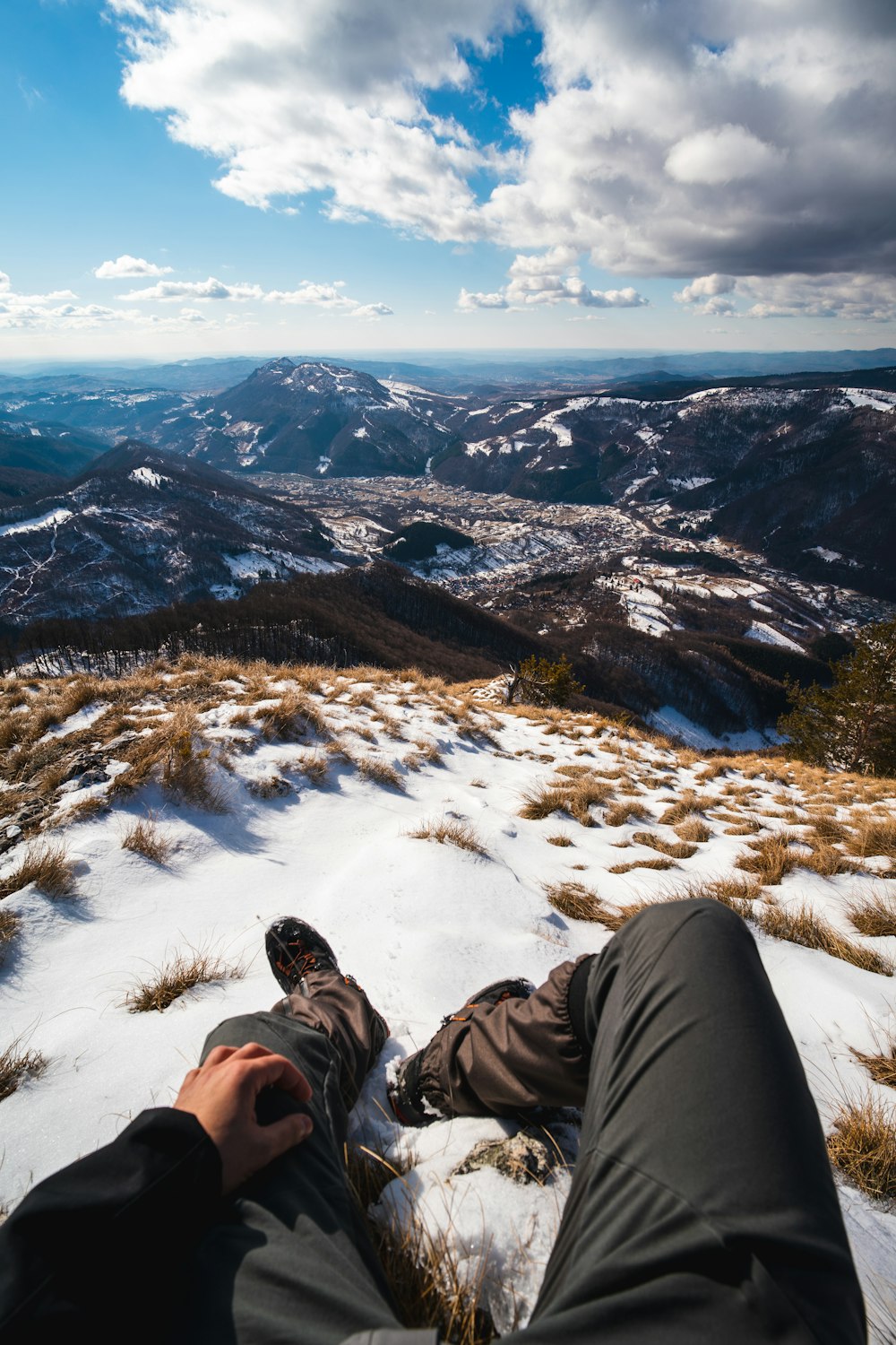 a person laying in the snow on top of a mountain