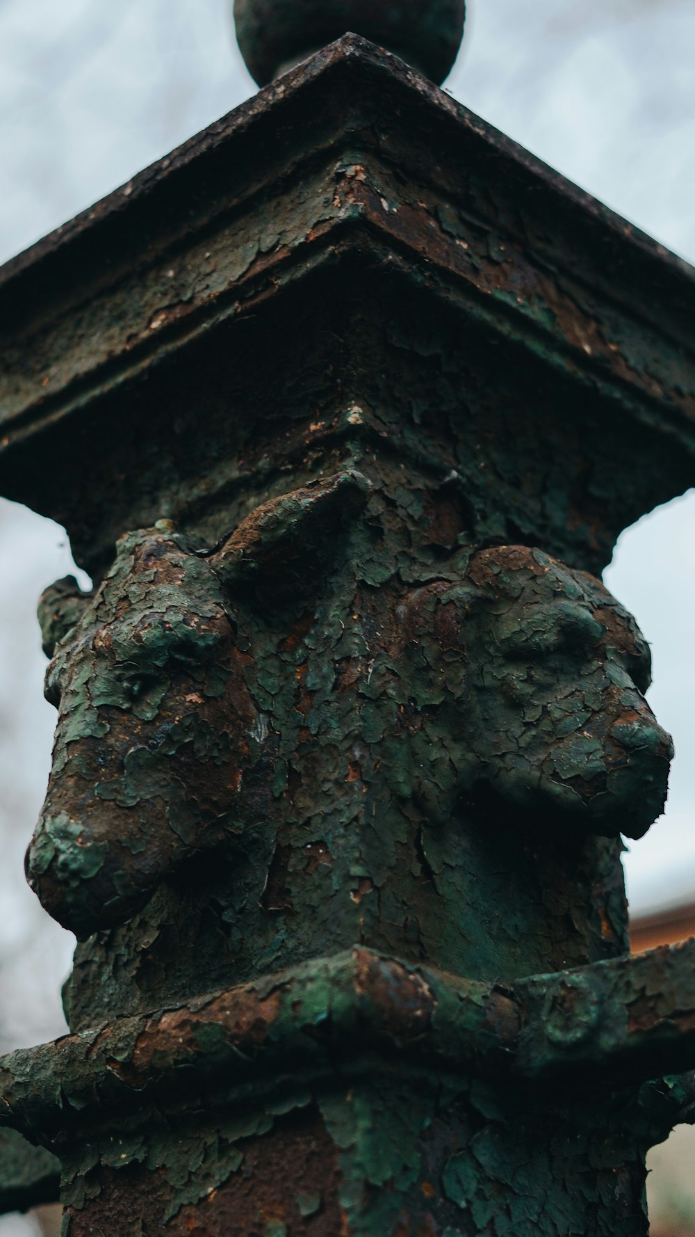 a close up of a rusted metal fence post