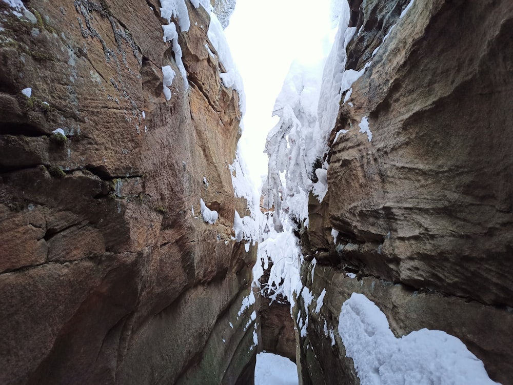 a narrow canyon is covered in snow and ice