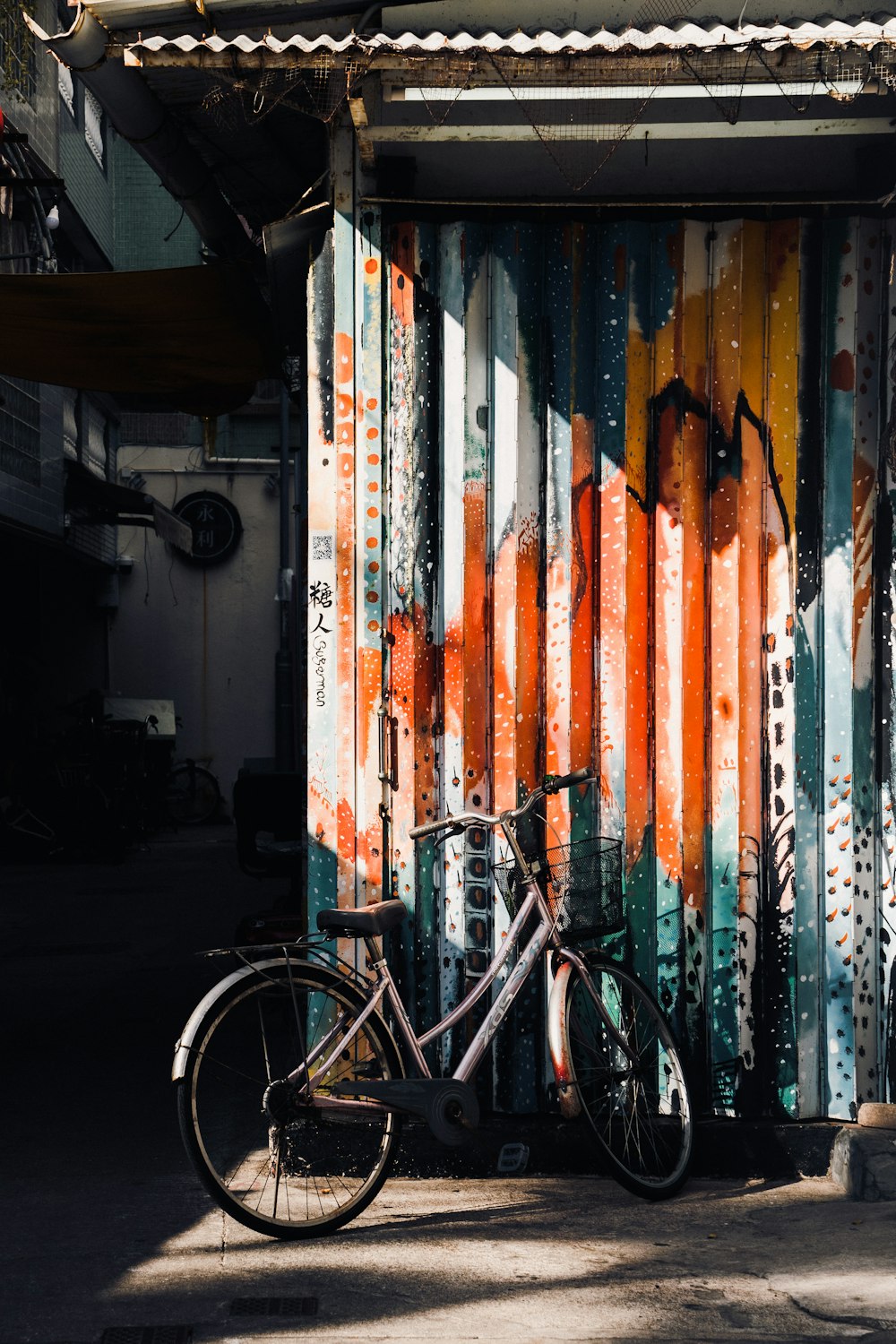 a bicycle parked next to a colorful wall