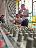 Group of students gathered around a radio broadcasting console during a live session