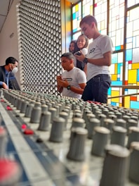 A group of sound technicians working together on a live audio mixer at a church event.