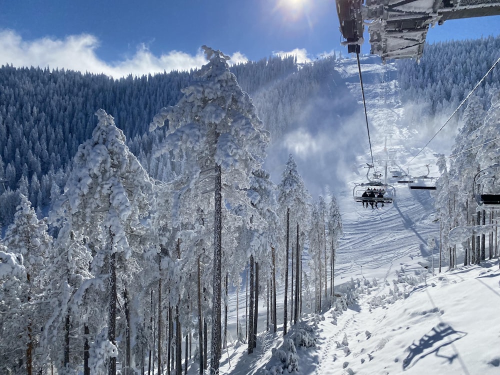 a ski lift going up a snowy mountain