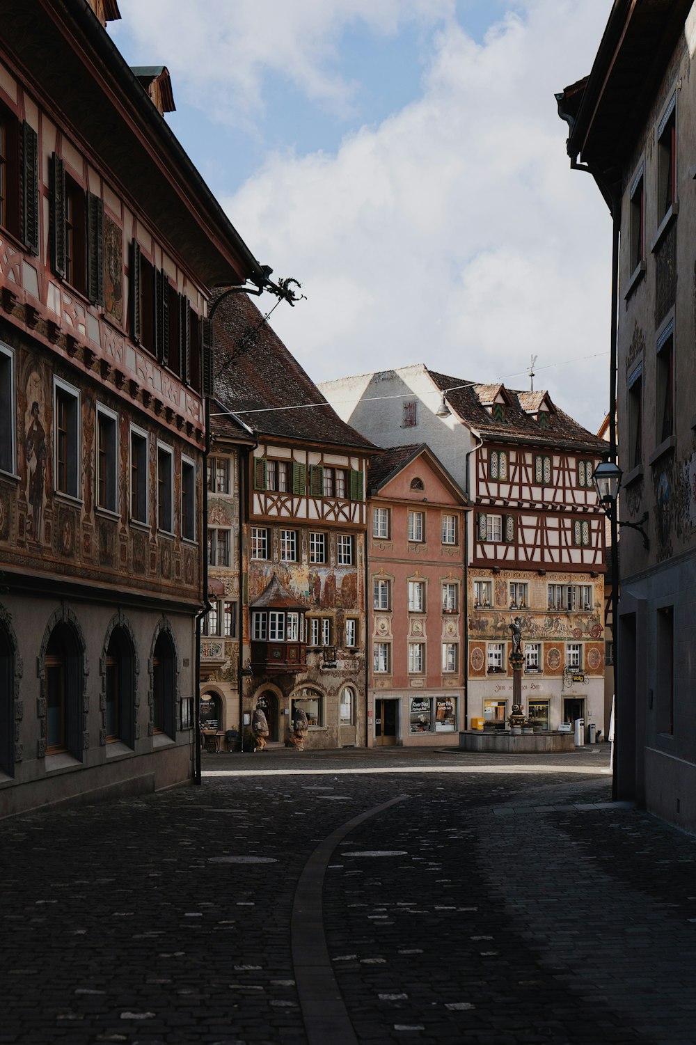 a cobblestone street lined with old buildings