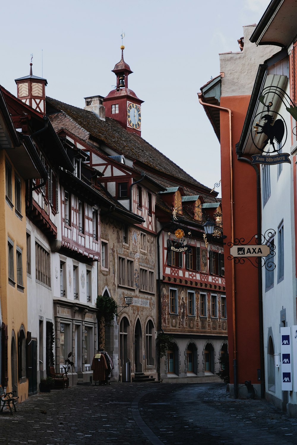 a street with buildings and a clock tower in the background