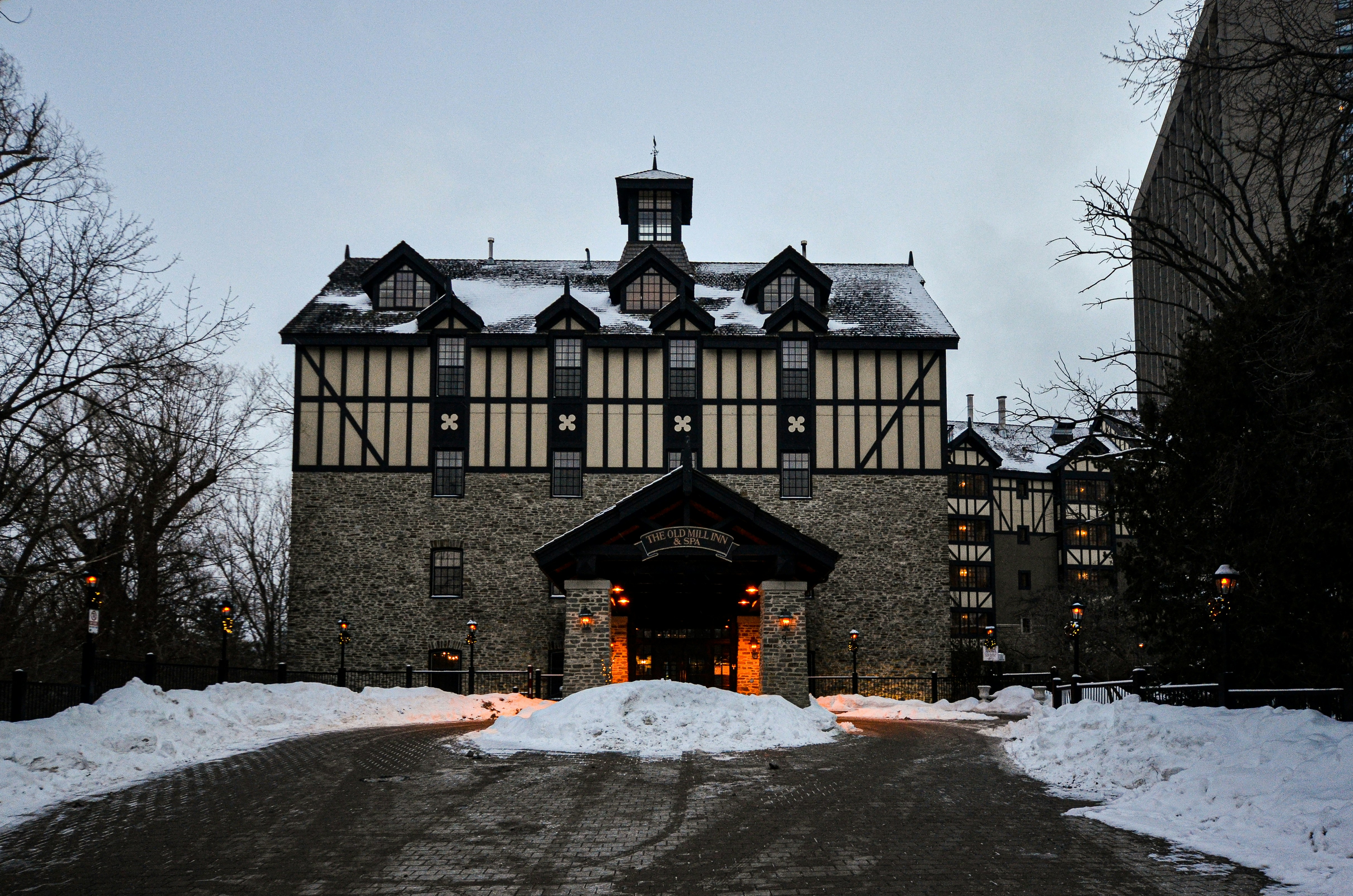 a large building with a lot of snow on the ground, The relaxing hue of the old mill spa