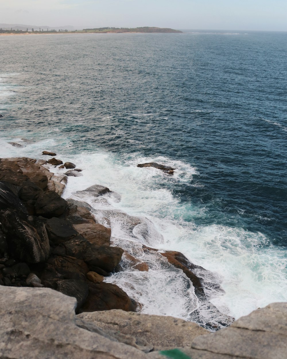 a view of the ocean from a rocky cliff