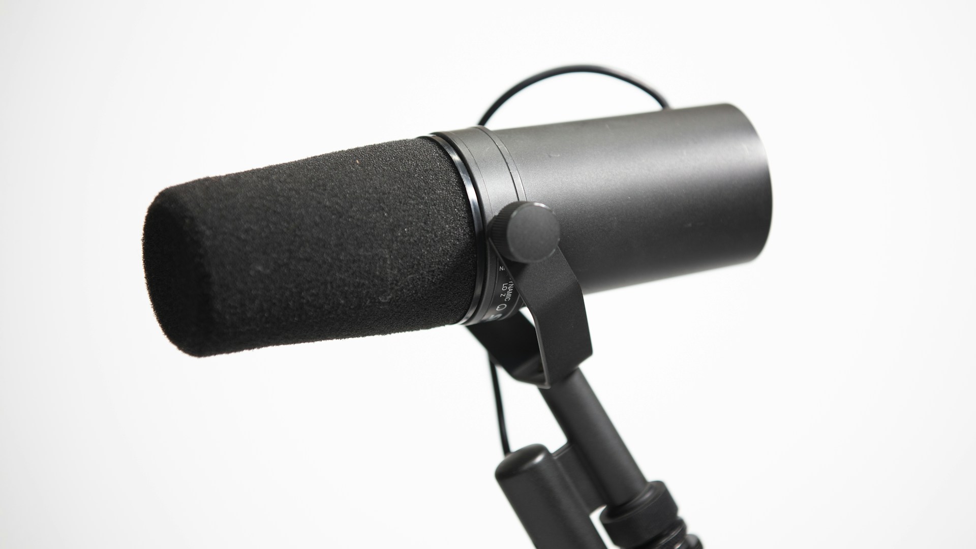a microphone attached to a tripod on a white background