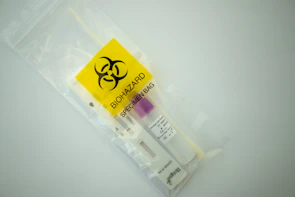 Close-up of a sealed DNA sample kit ready for secure transport.