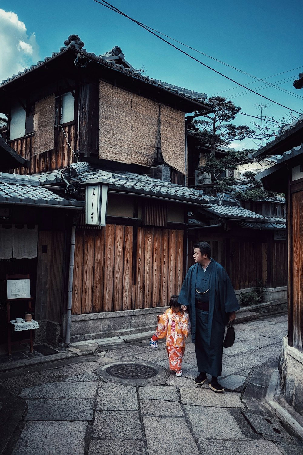 a man and a child walking down a street
