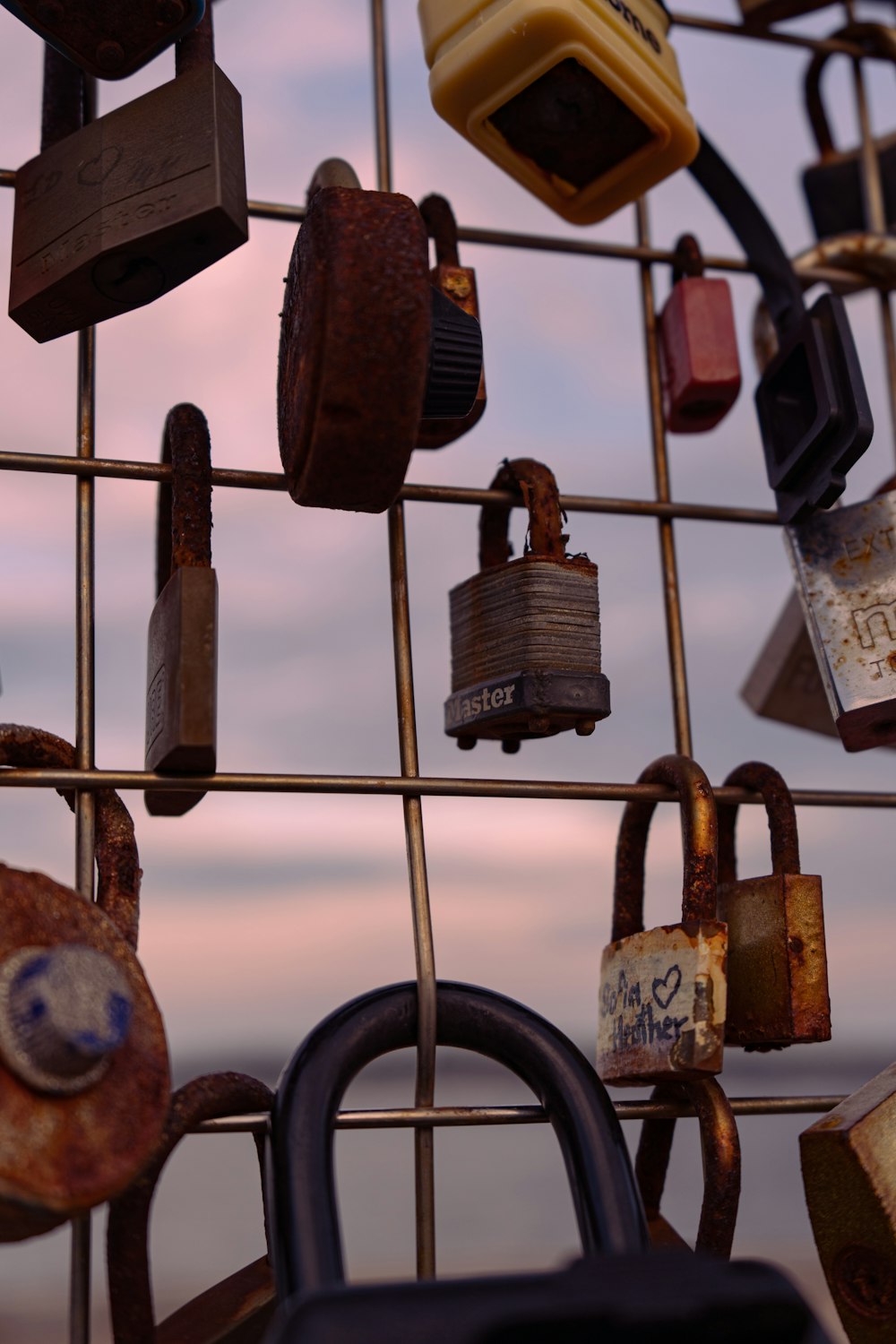 a bunch of padlocks are hanging on a wall