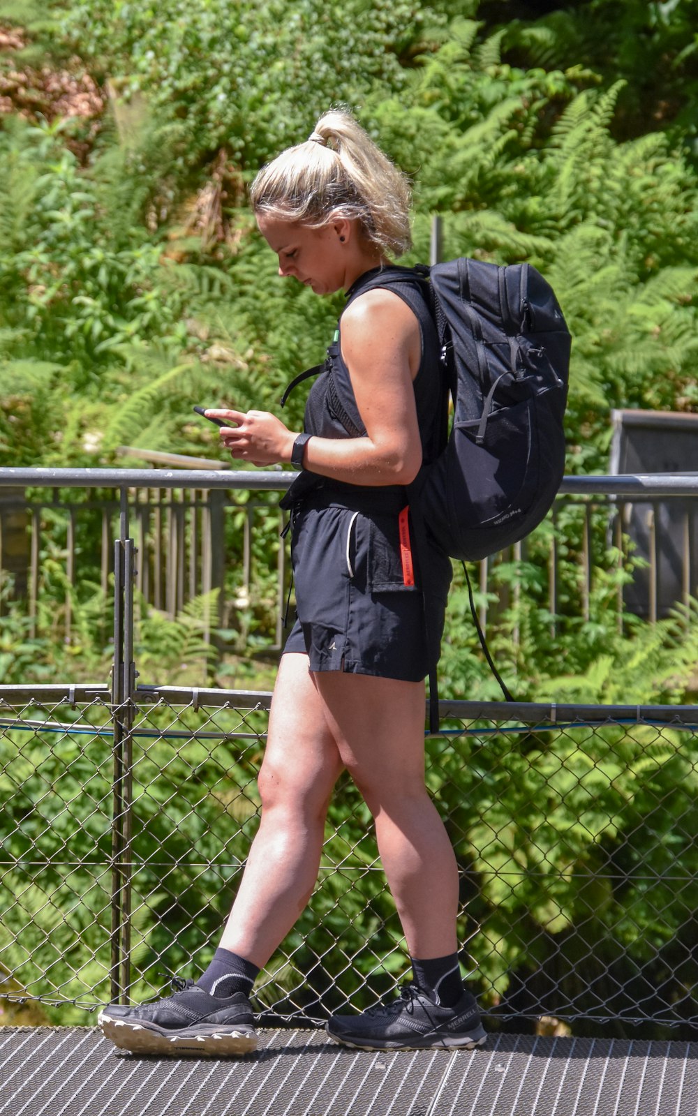 Una mujer con una mochila camina sobre un puente