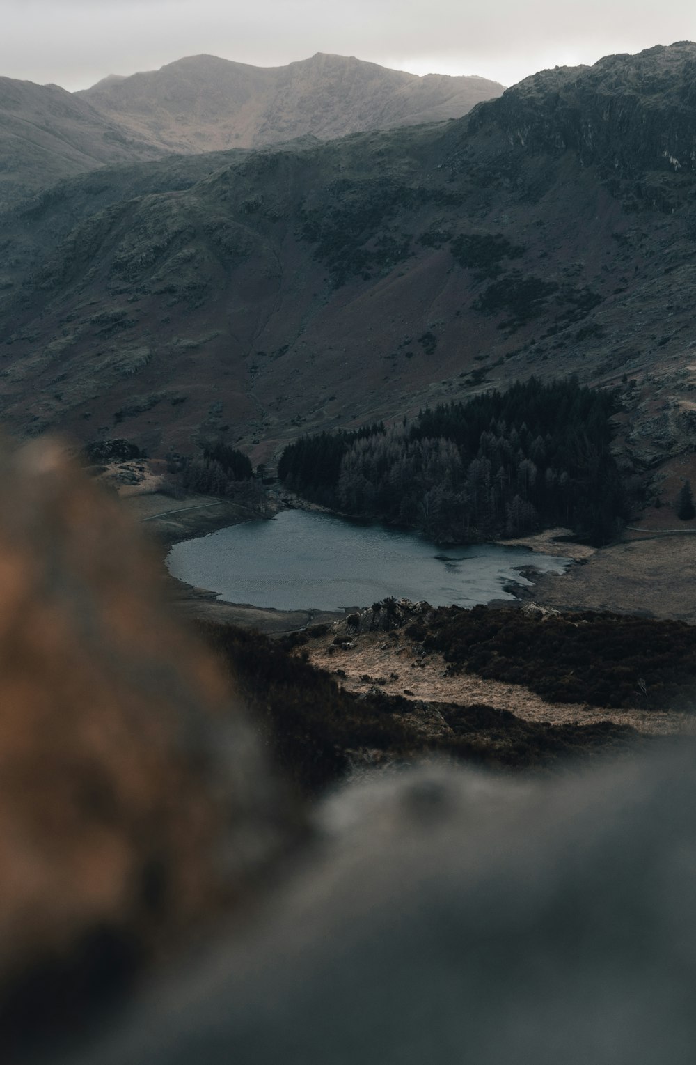 a mountain range with a lake in the foreground