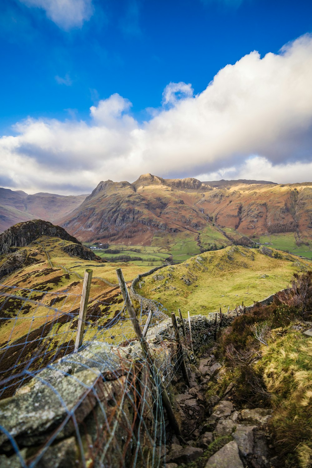 a fenced in area with mountains in the background