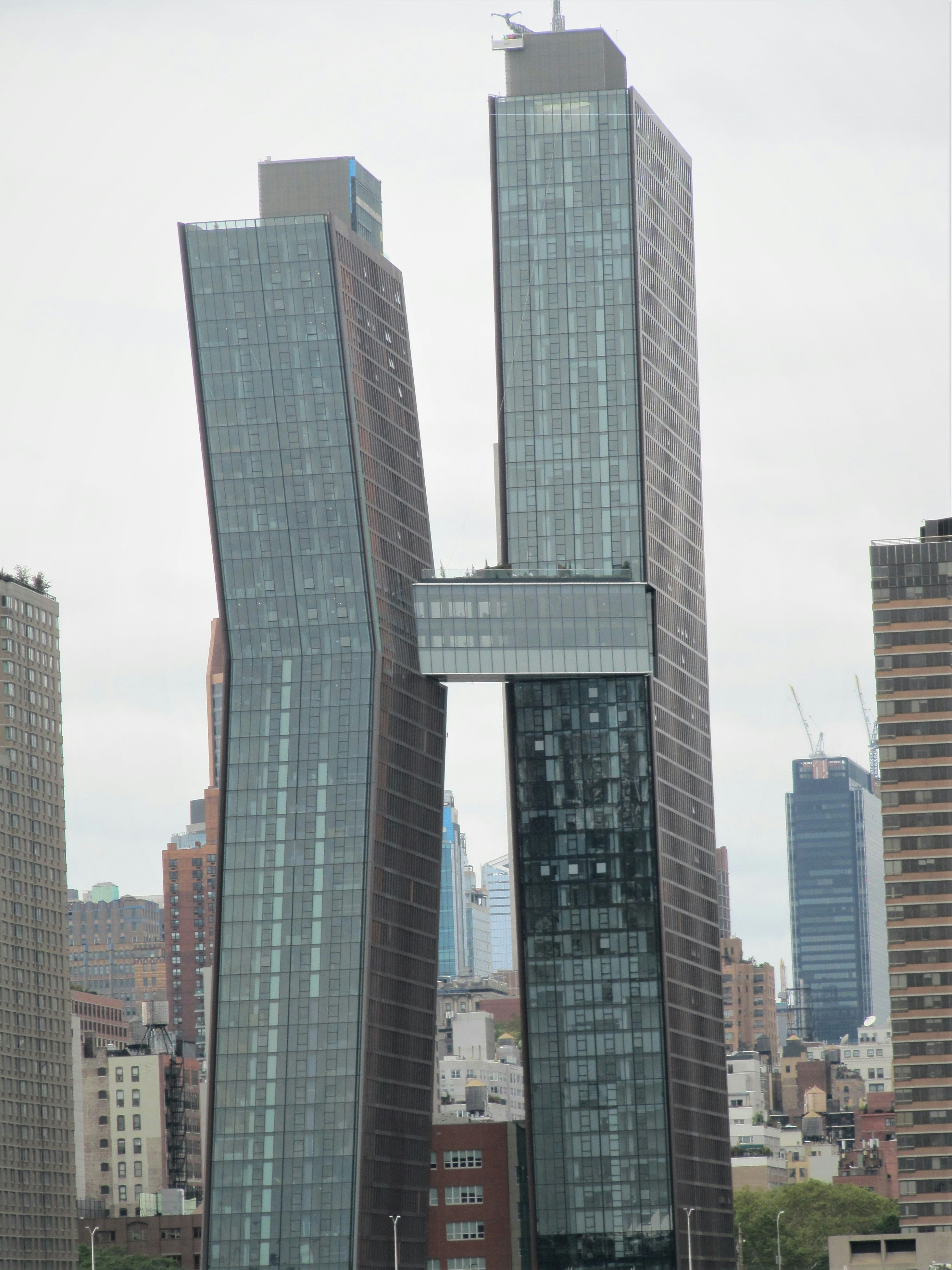 A couple of tall buildings sitting next to each other photo – Free ...