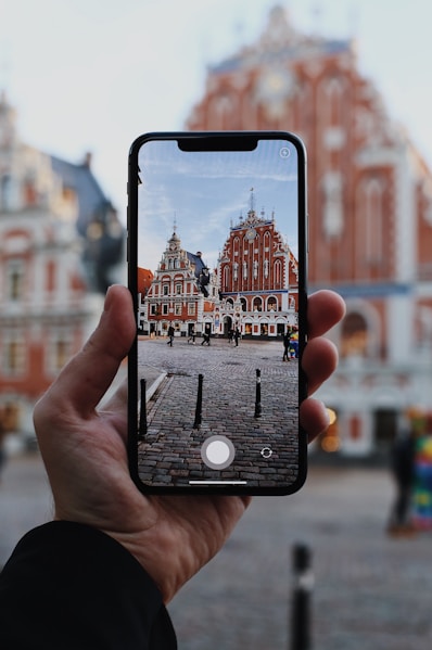 a person taking a picture of a building with their cell phone